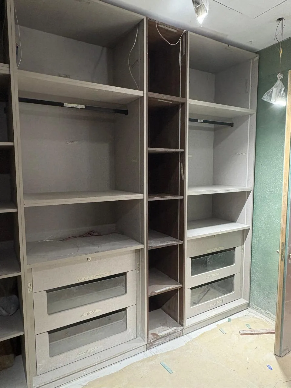 Wardrobe internal storage being prepared for shutters and hardware