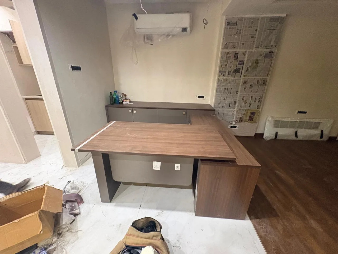 Custom desk and wall preparation at an active interior site
