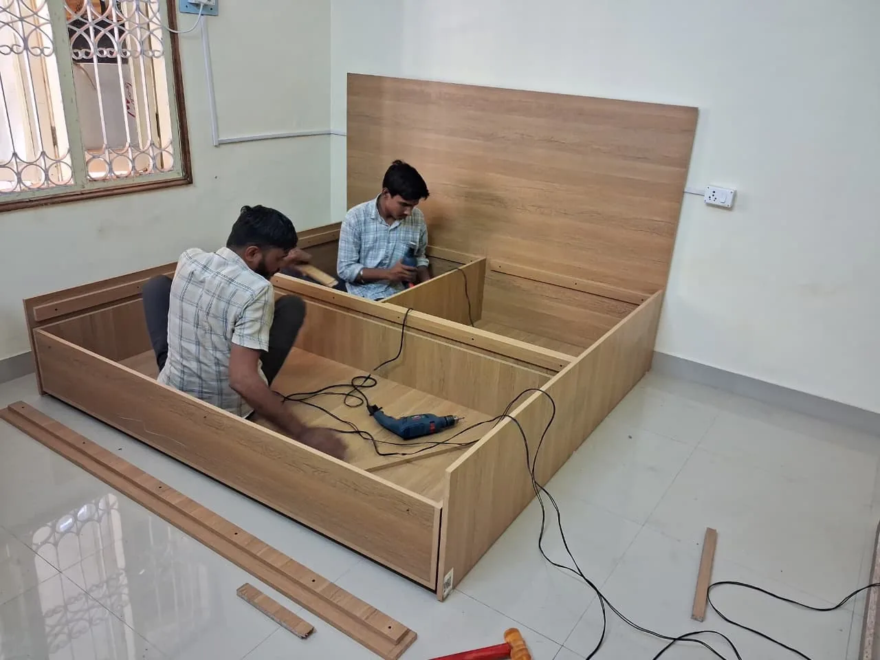 Installation team fitting storage bed components on site